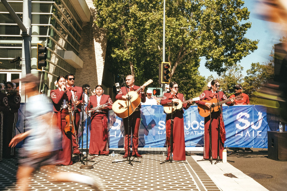 Mariachi band playing as a runner passes on the San Jose Half Marathon course